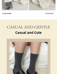 Detail of grey cotton socks featuring cartoon cat patterns and soft knit texture