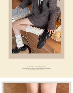 Detailed texture of thick knit leg warmers in cream, dark grey and light brown tones