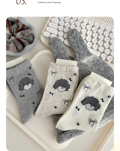 Three pairs of soft cotton socks in grey and white with cute puppy and bow patterns