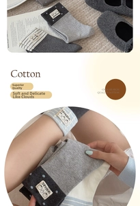 Detail of cotton mid-calf socks with striped patterns and handmade fabric label