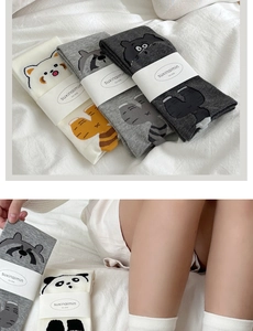 Detailed view of cute 3D cartoon raccoon cotton socks in white and grey tones