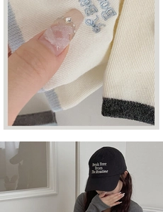 Detail of knitted sweater with blue embroidered letters and cotton baseball cap with text