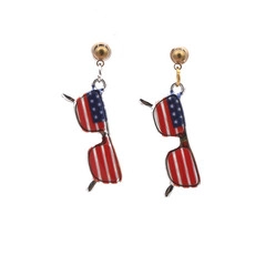 Detail of gold earrings with American flag pattern sunglasses shaped pendants