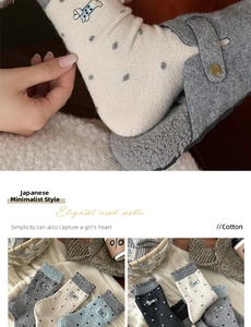 Close-up of Japanese style wool socks featuring cute dog embroidery and polka dots