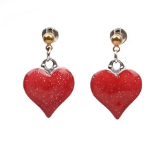 Macro shot of red heart pendant earrings with gold ball studs and silver glitter inlay