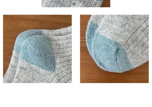 Detailed close-up of color-block knit texture and stitching on winter wool socks