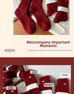 Detail view of red wool socks showing cable knit and striped textures with paper packaging