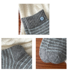 Detailed close-up of gray wool socks featuring blue stripes and decorative buttons