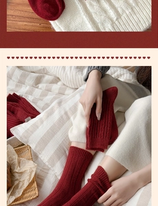 Close-up of dark red wool mid-tube socks with ribbed texture and small M letter label