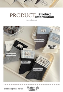 Detail of 5 pairs of cotton socks in grey and blue with dog patches and striped patterns