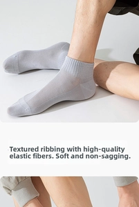 Close-up of light grey breathable mesh socks featuring elastic ribbed cuffs for comfort