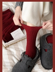 Detail of red ribbed thermal wool socks showing excellent stretch and soft knit texture