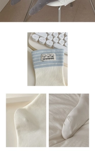 Close-up of cute dog labels and fine knitting on striped cotton mid-tube socks