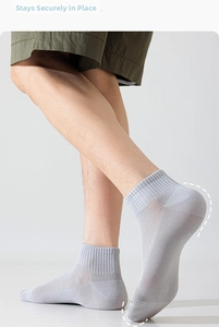 Detail view of light grey athletic socks with breathable mesh and ribbed cuffs