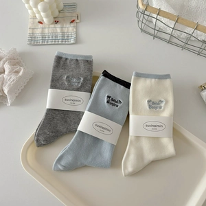 Three pairs of cotton crew socks in grey, blue, and cream with Bébé Bonjour embroidery