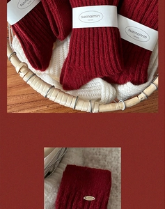 Macro shot of dark red wool socks with vertical rib texture and metal brand tag