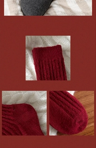 Close-up detail of thick red wool socks with ribbed knit texture for winter warmth
