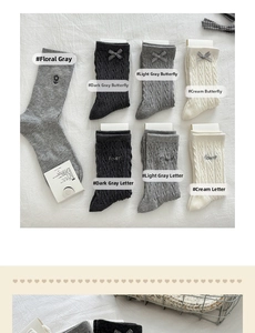 Flat lay of gray and cream knit crew socks with flower embroidery and bow details