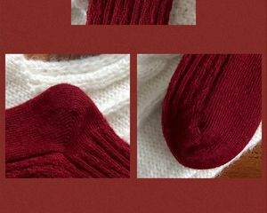 Detail of red wool knit socks with vertical stripes showing premium stitching and texture