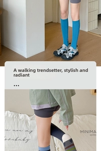 Close-up of blue compression athletic socks paired with outdoor running shoes and hoodie