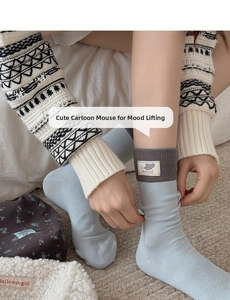 Detail of light blue cotton socks with mouse patch and geometric jacquard leg warmers