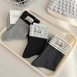 Set of three cotton crew socks with cartoon dog labels in gray, stripes, and patterns