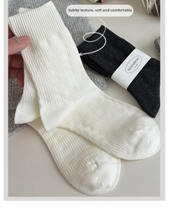 Detail of vintage textured crew socks featuring intricate jacquard knit patterns