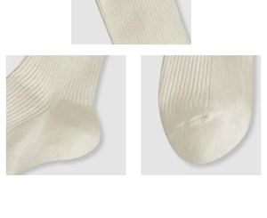 Macro detail of ribbed knit socks showing the soft fabric, heel and toe seam craft