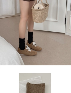 Braune Freizeitschuhe aus Wildleder mit weißen Schnürsenkeln und schwarzen Socken