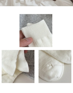 Detail of white cotton knitted socks showing elastic ribbed cuffs and fine texture