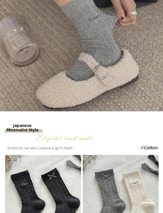 Macro detail of Japanese style cotton socks with cable knit, bow and flower embroidery