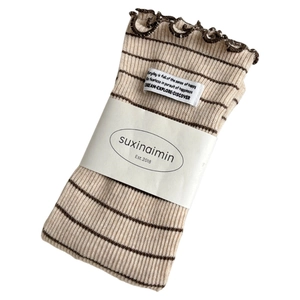 Japanese style beige striped crew socks with ruffled edges and fabric label detail