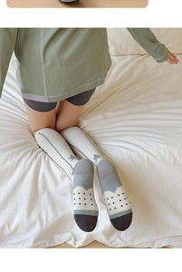 Detail view of compression knee-high sports socks with ribbed texture and star pattern