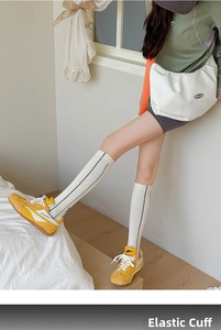Detail of elastic ribbed cuffs on white compression athletic knee-high sports socks