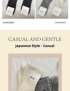 Detailed knit texture and flower embroidery on Japanese style crew socks in grey and beige