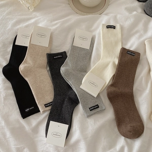 Stylish ribbed mid-calf cotton socks in neutral earth tones with chic fabric labels
