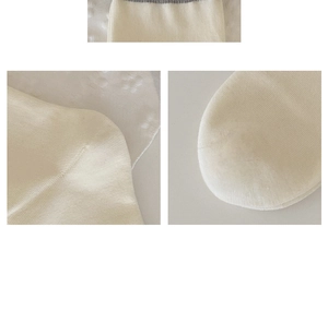 Detailed knit texture and reinforced seams on a cream-colored mid-tube cotton sock