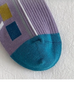 Detail of color-block knit athletic socks with ribbed texture and geometric patterns