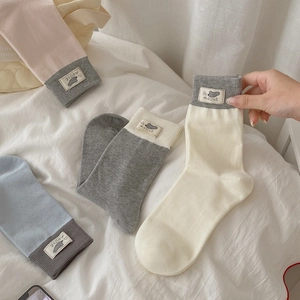 Set of four pastel crew socks with cute mouse tags in pink, grey, blue and beige tones