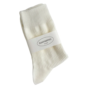 Minimalist beige ribbed crew socks for women featuring elegant vertical texture and card