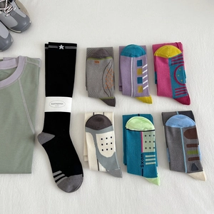 Set of 7 colorful compression crew socks for yoga and fitness in various geometric patterns