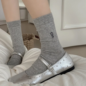 Silver Mary Jane flats with metal studs paired with gray embroidered crew socks