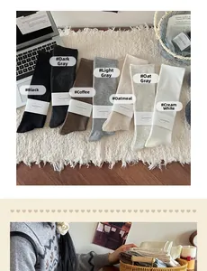 Close-up of seven Morandi color cotton knit knee-high socks for women in autumn and winter