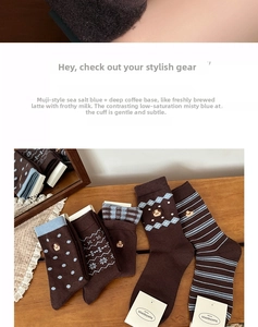 Detail of assorted crew socks with puppy embroidery and patterns on vintage wooden table