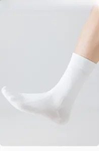 Detailed view of white cotton crew socks with ergonomic 90-degree heel design for men