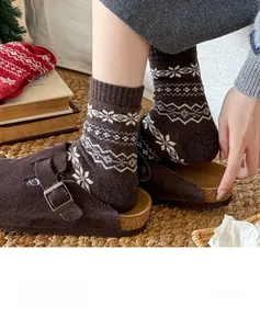 Detailed knit texture of wool socks with Fair Isle snowflake pattern and cork buckle shoes