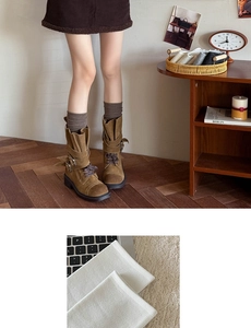 Close-up of knit calf socks texture and vintage suede buckled boots details