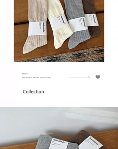 Close-up of ribbed cotton crew socks in earth tones with branded paper card packaging