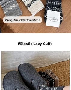 Detail of wool socks with Fair Isle snowflake pattern and cozy home styling with slippers