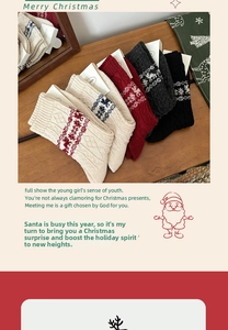 Detailed flat lay of Fair Isle wool socks with reindeer and snowflake knit patterns
